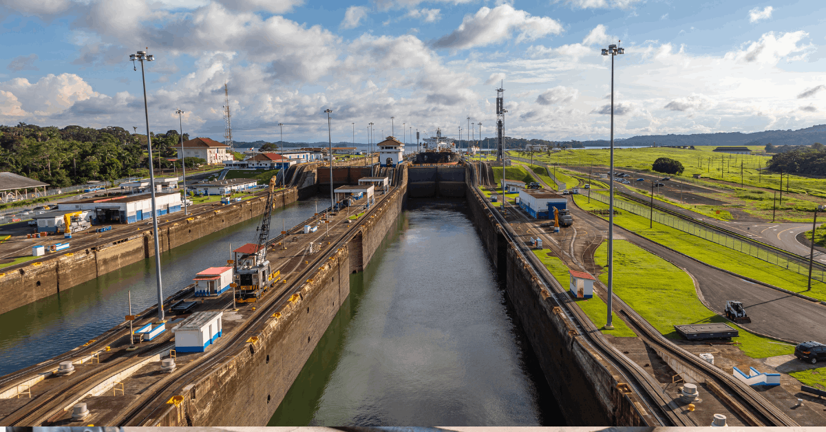 Panama Canal Shipping Alternatives for Gulf Shippers Ftr Image Container ship transiting the Panama Canal beside a double-stack intermodal train — Panama Canal shipping alternatives for Gulf Coast freight